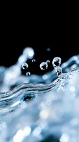Macro photography of pure water drops splashing and floating above dynamic wave surface against black background, creating ethereal aqua motion effect.