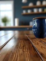 Navy blue ceramic cup on rustic wooden table surface with blurred cafe interior background, natural lighting highlights wood grain texture and creates cozy atmosphere.