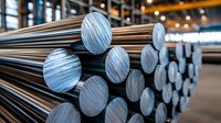 Stacked metal steel round bars in industrial warehouse. Raw aluminum or steel rods storage at metalworking factory. Manufacturing and metallurgy concept.