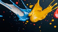Dynamic splash of blue and yellow paint colliding in mid-air against dark background with colorful droplets creating artistic abstract composition.