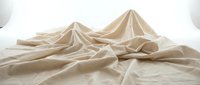 Draped beige linen fabric with flowing folds and peaks on white background, isolated for design, textile, and fashion projects.
