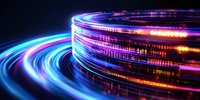 Glowing spiral light trails with vibrant blue, purple and orange colors creating dynamic circular motion effect against dark background. Digital technology concept.