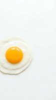 Fresh fried egg with golden yolk on white background isolated for cooking and breakfast design concepts.