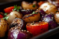Grilled colorful vegetables with charred marks and seasonings, including pearl onions, cherry tomatoes and purple onions, garnished with fresh herbs and spices.