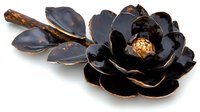 Black and gold decorative ceramic flower with glossy petals and metallic accents on white background, handcrafted artistic piece for luxury home decor and interior design.
