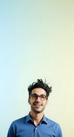 Young South Asian male professional wearing eyeglasses and blue button-up shirt, smiling confidently against gradient blue-to-yellow background for corporate, business, and lifestyle applications.