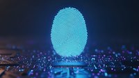 Digital fingerprint hologram glowing in cyan blue light over futuristic circuit board background for cybersecurity and biometric authentication technology.