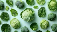 Fresh green cabbage and broccoli pattern on light background. Organic vegetables layout with natural texture and vibrant color for healthy eating concept.