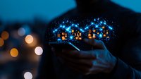Glowing magical city silhouette floating above smartphone in hands at night with bokeh lights and sparkles, digital transformation concept for smart technology.