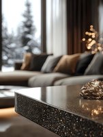 Cozy winter living room with modern granite coffee table, plush sectional sofa, and soft bokeh lights against snowy window view creating luxurious atmosphere.