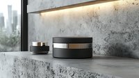 Minimalist black cosmetic jars on concrete shelf against textured gray wall with ambient lighting, modern luxury skincare packaging mockup for beauty products.