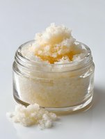 Homemade sugar scrub in glass jar with grainy texture, natural skincare exfoliant for spa treatments and beauty routines.