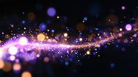 Magical glowing particles with purple and orange bokeh lights floating on black background create dreamy cosmic effect. Suitable for festive designs and celebrations.