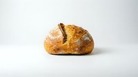 Freshly baked artisan bread loaf with golden crust and rustic scoring on clean white background isolated for bakery and food design projects.