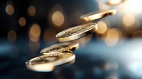 Golden coins falling in air with blurred bokeh lights background, dramatic lighting creates luxury financial concept for wealth and investment success.