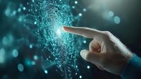 Human finger touching glowing digital network with particles and bokeh effects on dark background, representing technology connection and artificial intelligence.