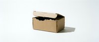 Open brown cardboard shipping box with torn flap on white background, isolated packaging container for e-commerce delivery and storage needs.