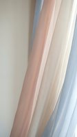 Soft pastel curtains in pink and blue tones creating elegant window treatment for modern interior design and home decor applications.