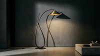 Modern arc floor lamp with curved metal frame and brass shade casting warm light in contemporary interior space.