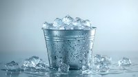 Metal bucket filled with crystal clear ice cubes and water droplets on light background, fresh cold drink concept for beverage and cocktail photography.