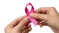 Hands holding pink awareness ribbon for breast cancer support and healthcare advocacy campaigns on white background.