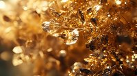 Macro shot of golden crystal formations with intricate geometric patterns and light reflections creating a luxurious abstract background with bokeh effect and depth of field.