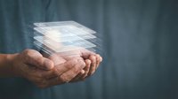 Hands holding stacked digital documents or data files floating above palms, representing cloud storage, file transfer, document management, and digital information technology solutions.