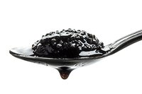 Black caviar on silver spoon with dripping liquid, luxury gourmet delicacy isolated on white background for high-end culinary presentation.