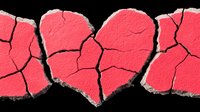Broken red hearts with cracks and rough edges on black background symbolize heartbreak, relationship problems, and emotional pain. Artistic concept for Valentine's day.