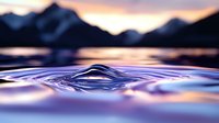Macro water drop splash creating symmetrical crown formation against mountain silhouette at sunset, purple and orange reflections on calm lake surface.