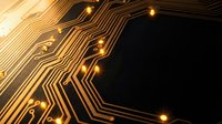 Golden circuit board traces with glowing connection points on dark background for technology and electronics design projects.