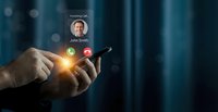 Caucasian male hands holding smartphone with incoming call notification glowing on dark blue background, modern communication concept.