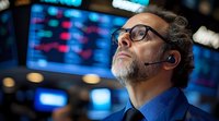 Mature businessman with headset and glasses looking up thoughtfully against blurred stock market display background, representing financial analysis and trading.