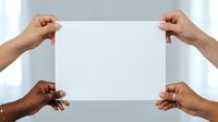 Diverse group of people holding blank white paper together, representing teamwork, unity, collaboration and community support for business projects and social causes.