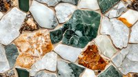 Colorful natural mineral crystals and stones in flat lay composition showing varied textures and patterns of white, green, and amber specimens on light background.