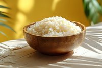 Steamed white rice in wooden bowl on bamboo mat with tropical palm leaves shadow and golden wall background, bright sunlight effect.