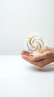 Hands holding glowing spiral orb with gold and silver swirls, isolated on white background for business, innovation, technology, and success concepts.