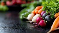 Fresh colorful root vegetables including carrots, radishes, turnips and black radish arranged in row on dark wooden background with herbs and copy space.
