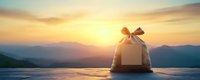 White gift box with bow against scenic mountain sunset panorama, golden sunlight illuminating package on wooden surface, romantic holiday atmosphere.