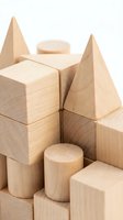 Wooden building blocks and geometric shapes arranged in castle-like structure on white background. Natural wood toy blocks including cubes, cylinders, and cones for children's construction play and educational development.