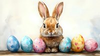 Adorable brown bunny sitting among colorful decorated Easter eggs in pastel blue, pink and yellow with hearts and stars pattern on soft blurred background.