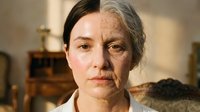 Split-face portrait showing young and elderly woman representing aging process, time passage, and life stages in warm indoor lighting.