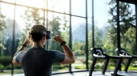 Young woman wearing virtual reality headset in modern gym with panoramic windows overlooking nature landscape during morning workout session.