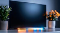 Modern home entertainment setup with LED strip lighting creating ambient blue and orange glow behind flat screen television, flanked by decorative plants for cozy atmosphere.