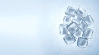 Scattered ice cubes on white surface with water droplets and condensation, suitable for beverage, refreshment, and cooling product advertising.