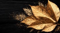 Golden autumn leaf disintegrating into glittering particles against dark background, dramatic lighting creates magical seasonal atmosphere for fall designs.