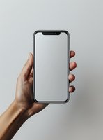 Female hand holding modern smartphone with blank white screen against neutral background. Mockup ready for app or website presentation.