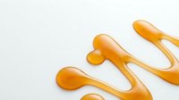 Isolated golden orange liquid splashes and drips on white background, perfect for design projects, web graphics, and creative compositions.