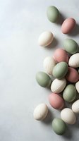 Pastel colored eggs in soft green, pink and cream tones scattered on light textured background for spring holiday celebrations and seasonal decorations.