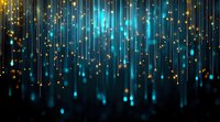 Magical glowing blue and gold light streaks falling from above against dark background, creating ethereal atmosphere for festive designs and holiday backgrounds.